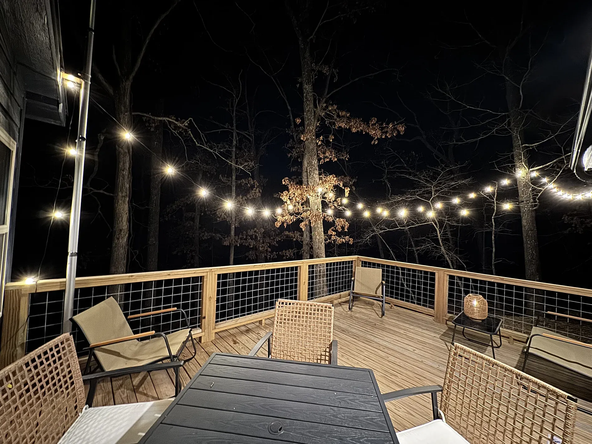 The deck at night under string lights